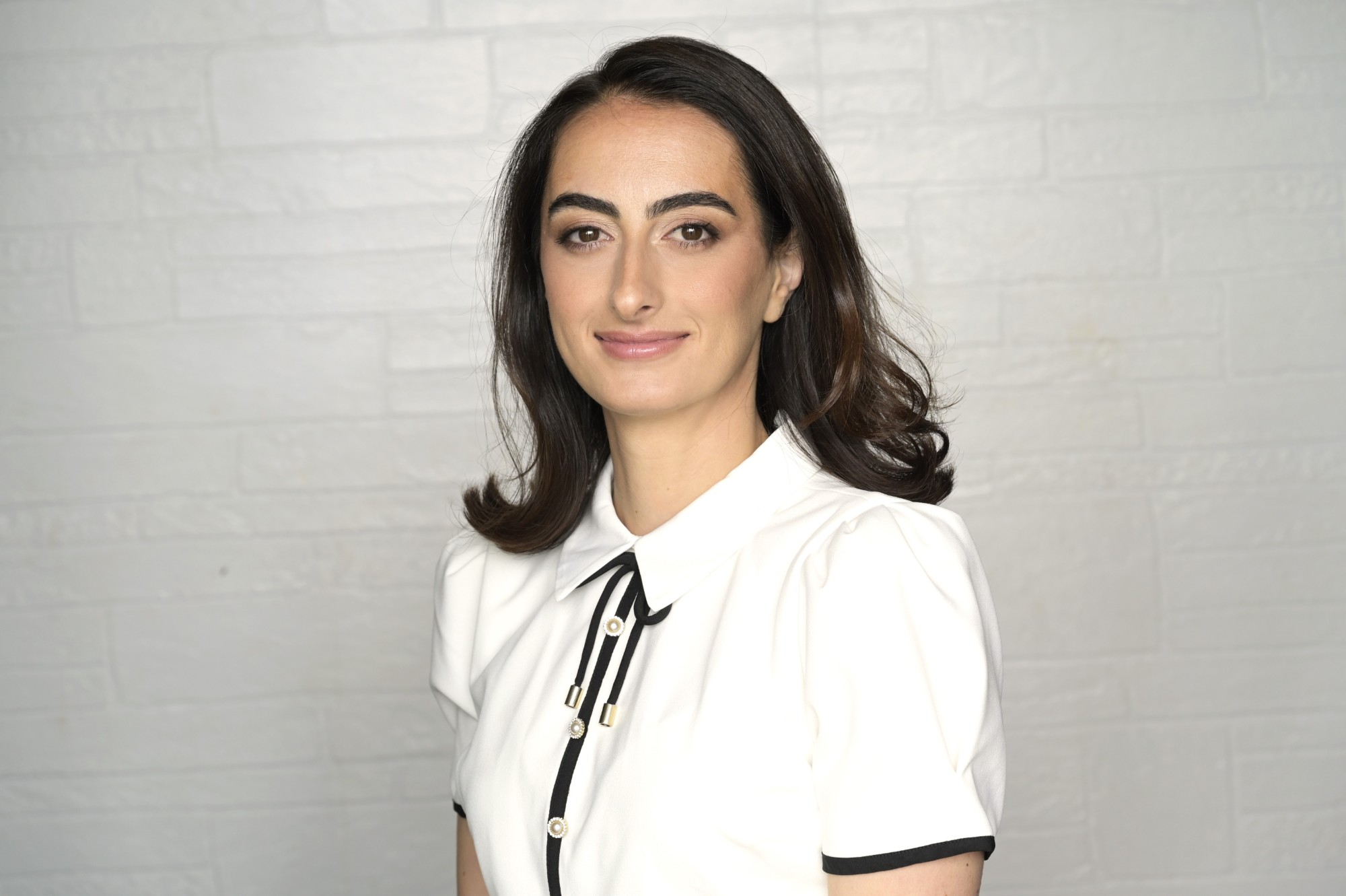 Ana Kamkhadze, Esq. MBA — professional portrait in white blouse